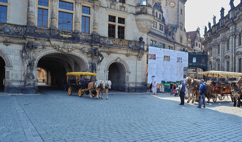 23 - The courtyard and ornate Renaissance architecture of the Dresden Castle (Dresdner Residenzschloss) in Dresden, Germany, featuring cobblestone paving and horse-drawn carriages